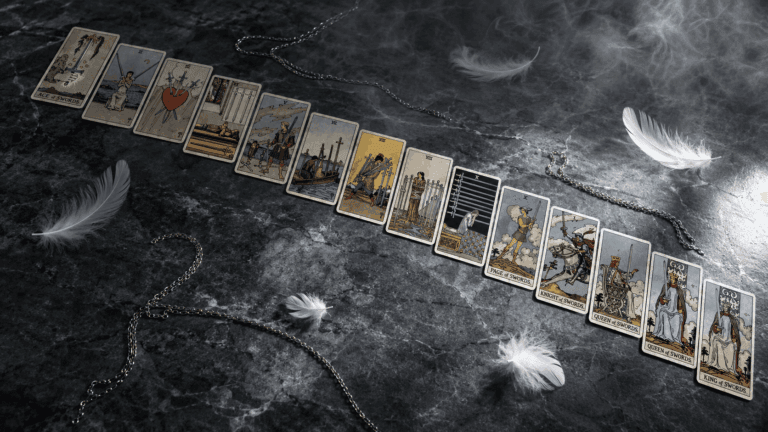Complete guide to Suit of Swords tarot cards arranged diagonally on grey stone with dramatic lighting and sword imagery