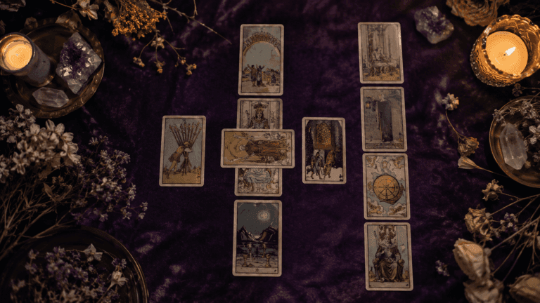 A tarot reader laying out ten cards in a celtic cross formation on dark velvet