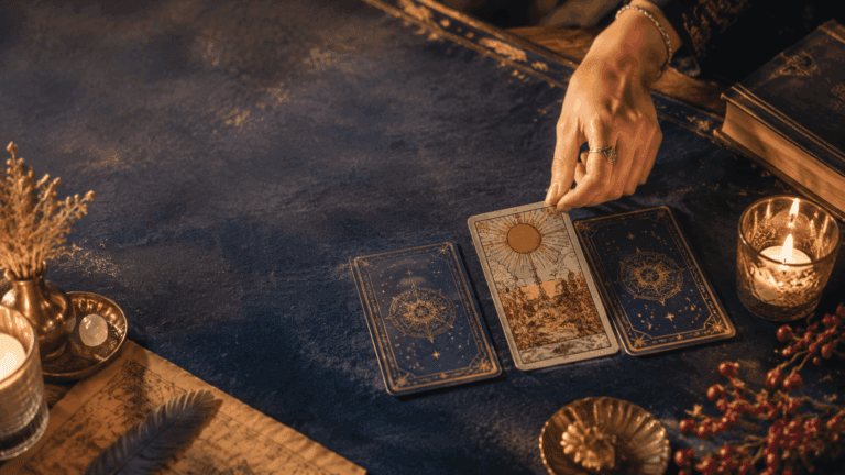 A tarot reader drawing one card from a small spread on a candlelit table, representing a yes or no tarot reading article header.